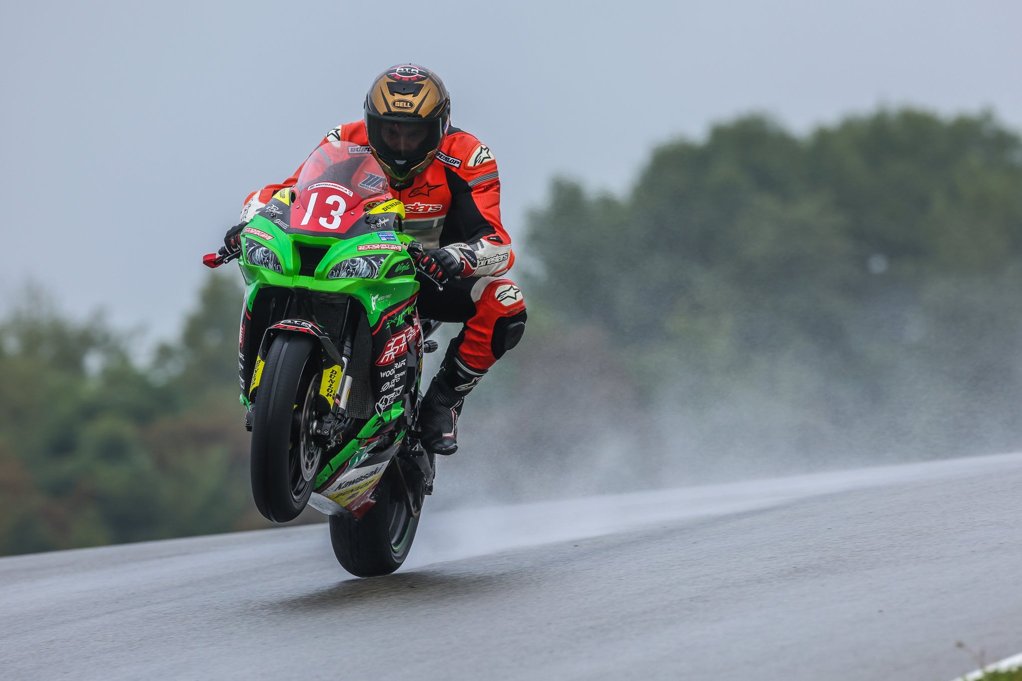 RTR rider lifting the front wheel in the rain